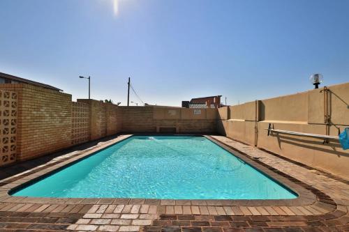 a swimming pool on top of a building at Sea facing apartment 1703 on High Tide Amanzimtoti in Amanzimtoti