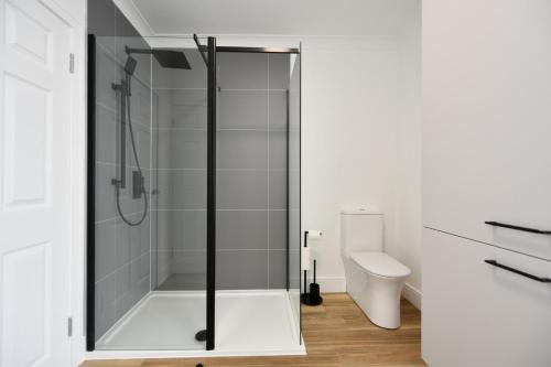 a bathroom with a shower and a toilet at Troon Portland Apt A in Troon