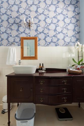 a bathroom with a sink and a mirror at House Falcon close to ZAH in Pretoria