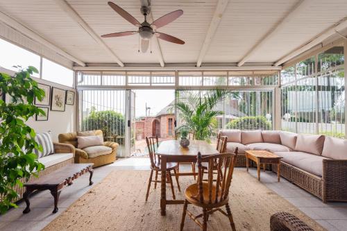 a living room with a ceiling fan and a table at House Falcon close to ZAH in Pretoria