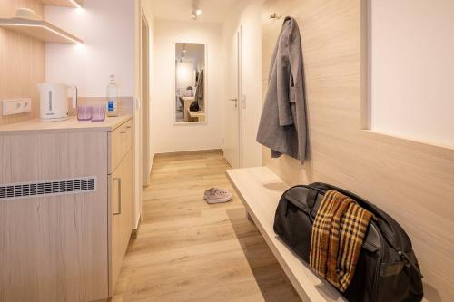 a small kitchen with a counter and a sink at Hotel Stranddistel in Norderney