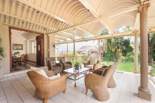 an outdoor living room with chairs and a table at House Falcon close to ZAH in Pretoria