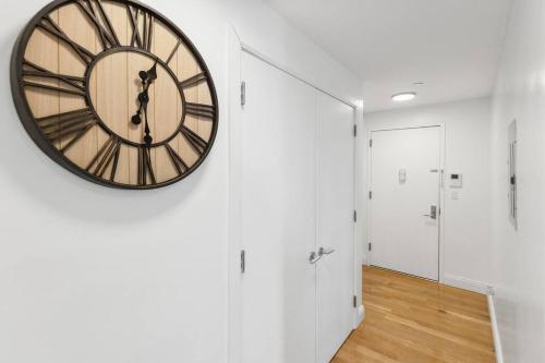 a large clock on a wall in a hallway at Flat In The Bush in Brooklyn