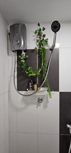 a bathroom with two plants on a wall at Empire City M Tower in Petaling Jaya