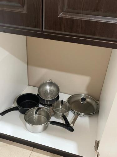 four pots and pans on a stove in a kitchen at Bernie's Basement in Milton