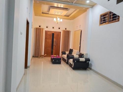 a living room with a couch and a chair at Griya Delvin in Temon