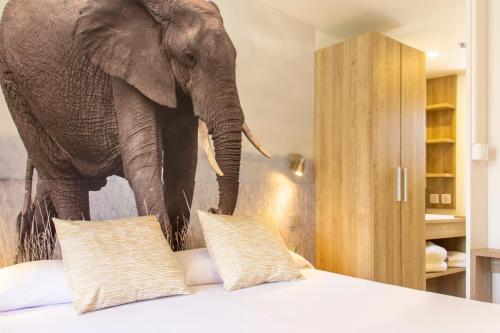 an elephant standing in a room with a bed at Sangulí Camping & Resort in Salou