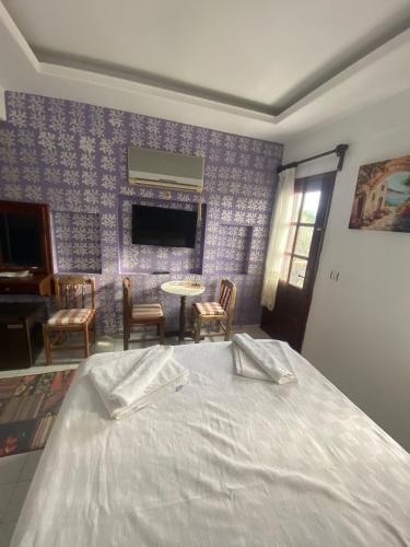 a bedroom with a bed and a table and chairs at Sevgi Hotel Kalkan in Kalkan