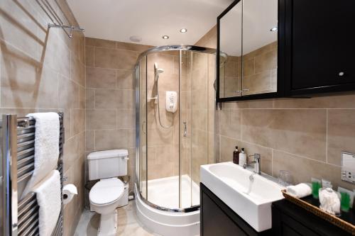 a bathroom with a shower and a toilet and a sink at The Townhouse Ayr - Luxury B&B in Ayr
