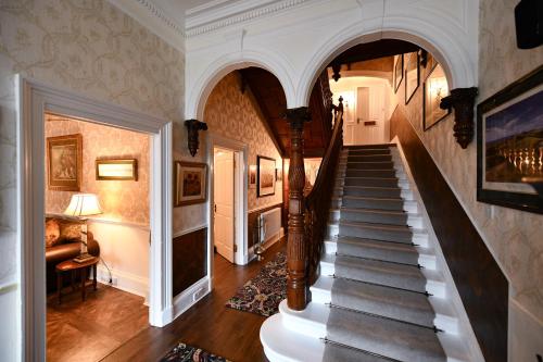 a hallway with a staircase in a house at The Townhouse Ayr - Luxury B&B in Ayr