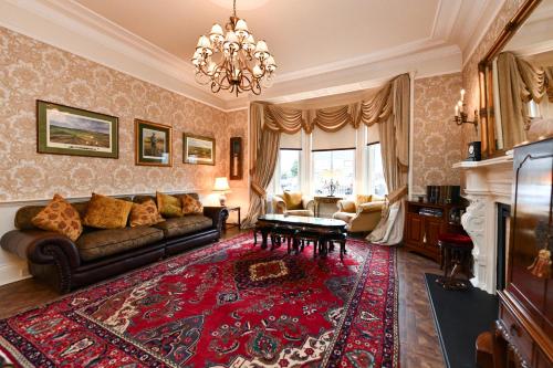 a living room with a couch and a red rug at The Townhouse Ayr - Luxury B&B - adults only in Ayr