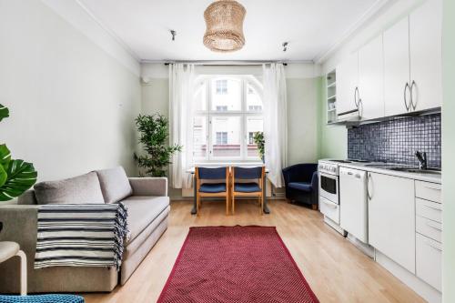 ein Wohnzimmer mit einem Sofa und einem Tisch in der Unterkunft Centrum - Lovely furnished Studio in Helsinki