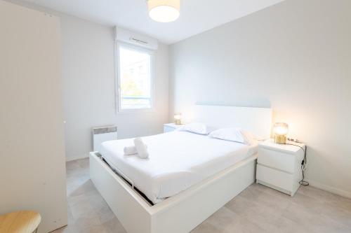 a white bedroom with a white bed and a window at Pastel colors - Tours in Tours