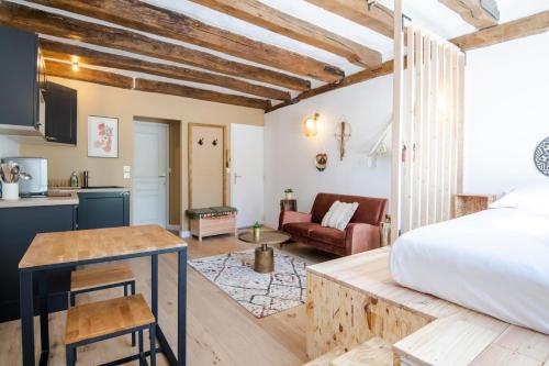 a bedroom with a bed and a living room at Let's get some height in Tours