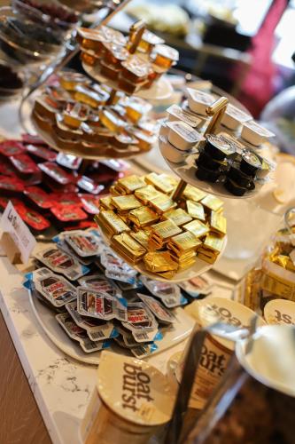 a table with lots of different types of gold bars at La Suite West - Hyde Park in London