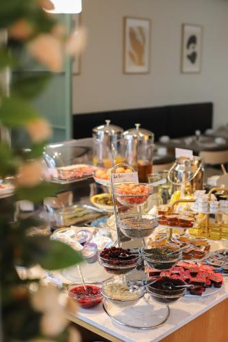 a buffet with many plates and bowls of food at La Suite West - Hyde Park in London