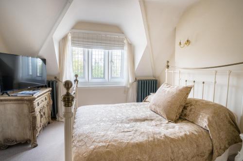 a bedroom with a bed and a flat screen tv at Berwick Lodge in Bristol