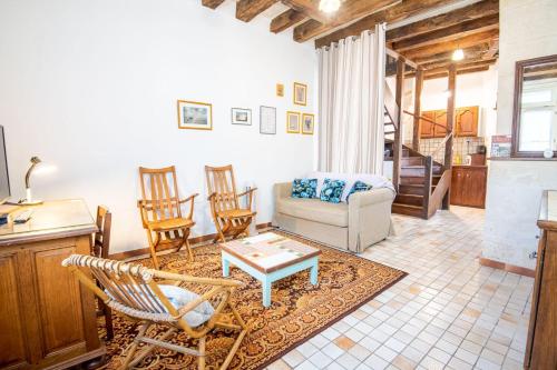 a living room with a couch and chairs and a table at L'authentique - Tours in Tours