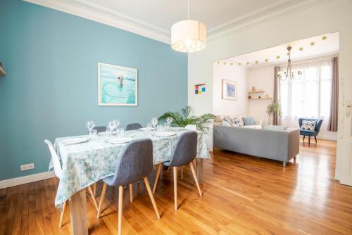 a dining room with a table and a couch at A corner of paradise in Tours