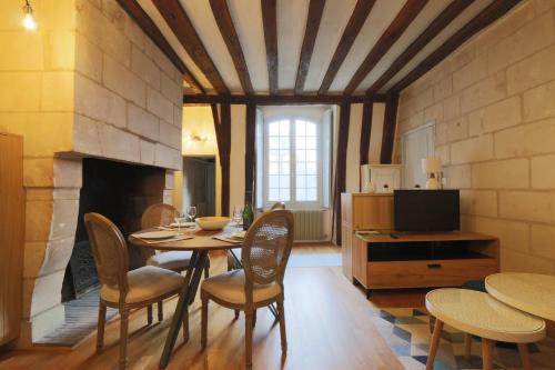 a dining room with a table and chairs and a fireplace at Lovely T2 in the heart of Tours in Tours