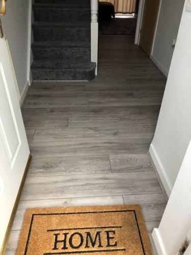 a homeoyer with a welcome mat on the floor at Airport house , Speke in Speke