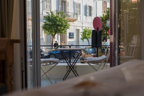 uma vista para uma varanda com uma mesa e cadeiras em Silo Luxury Rooms em Nafplio