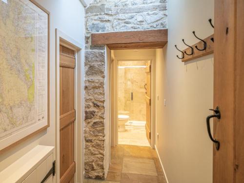 a hallway leading to a bathroom with a stone wall at 2 Bed in North York Moors National Park G0132 in Rosedale Abbey