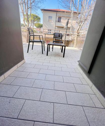 two chairs and a table on a patio at Hotel Villa Tina in Cesenatico
