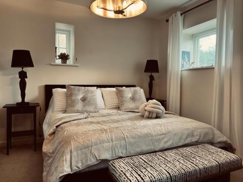 a bedroom with a bed with a stuffed animal on it at Immaculate 1-Bed Cottage in Moreton in marsh in Moreton in Marsh