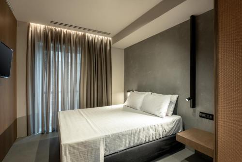 a bedroom with a bed and a large window at Zakro Luxury Living Chania in Chania Town