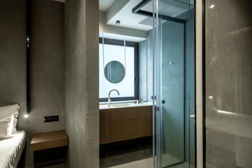 a bathroom with a glass shower and a sink at Zakro Luxury Living Chania in Chania Town