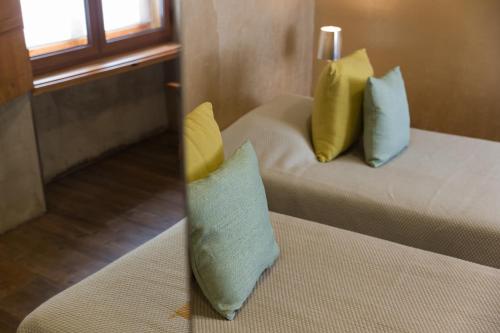 a room with two beds with yellow and blue pillows at Lisbon Art Stay Apartments Baixa in Lisbon