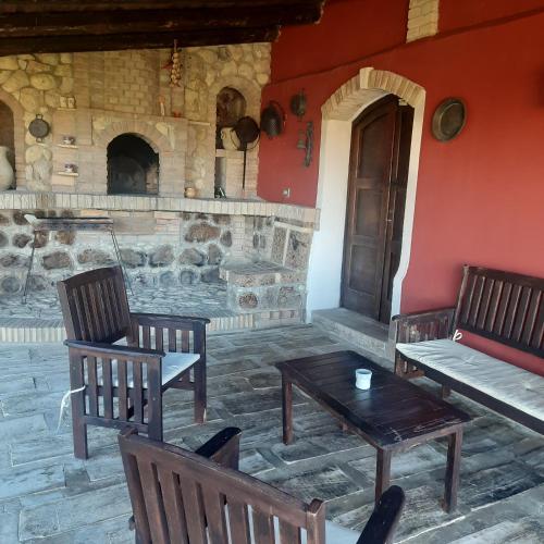a room with two chairs and a table and a fireplace at Casalustro in Citta' Sant'Angelo