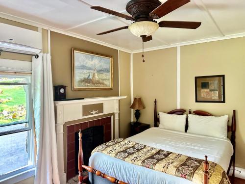 a bedroom with a bed with a fireplace and a ceiling fan at The Villas on Lake George in Diamond Point