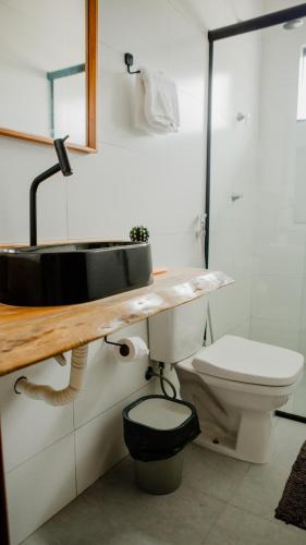 a bathroom with a sink and a toilet at Casa reserva boa vista in Barreirinhas