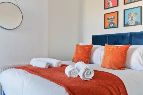 a bedroom with a bed with towels on it at Prime Location Stylish 4-Bed House near Trent Br in Nottingham