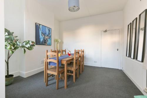 a dining room with a table and chairs at Prime Location Stylish 4-Bed House near Trent Br in Nottingham