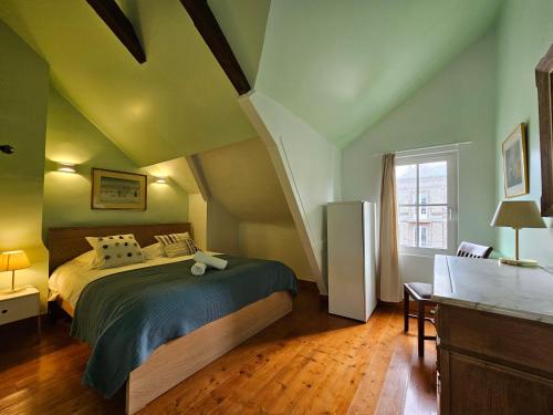 a bedroom with a large bed in a attic at Soleil du Matin in Étretat