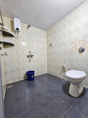 a bathroom with a toilet and a sink at Sirimudi Villa in Kundapur