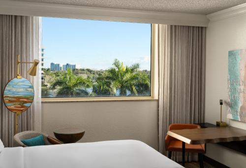 a hotel room with a bed and a large window at Renaissance Fort Lauderdale West Hotel in Plantation