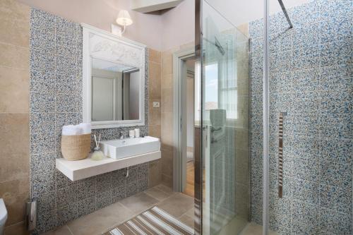a bathroom with a sink and a glass shower at Villa Elena in the heart of Istria in Ladići