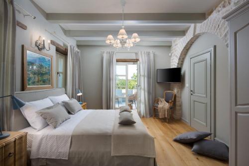 a bedroom with a large bed and a chandelier at Villa Elena in the heart of Istria in Ladići