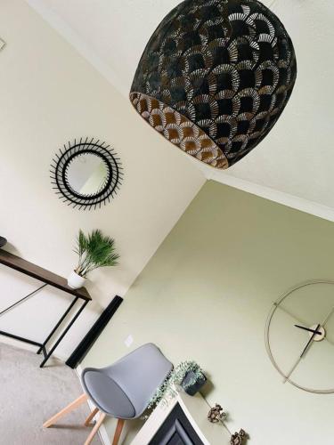 a room with a chair and a mirror on the ceiling at 3 Br House - Private Parking - Pool Table in Balderton