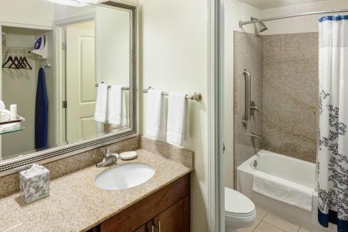 a bathroom with a sink and a toilet and a mirror at Residence Inn by Marriott Chicago Lake Forest/Mettawa in Mettawa