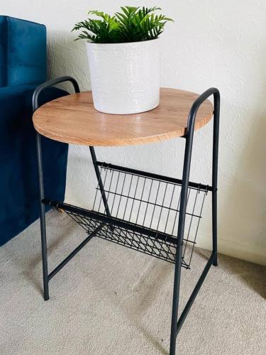 a small table with a plant on top of it at 3 Br House - Private Parking - Pool Table in Balderton