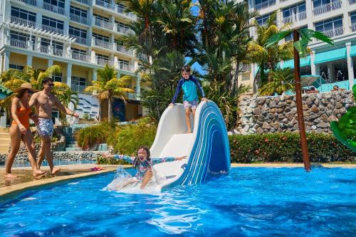 a group of people on a water slide at a resort at Gran Evenia Bijao - All Inclusive in Playa Blanca