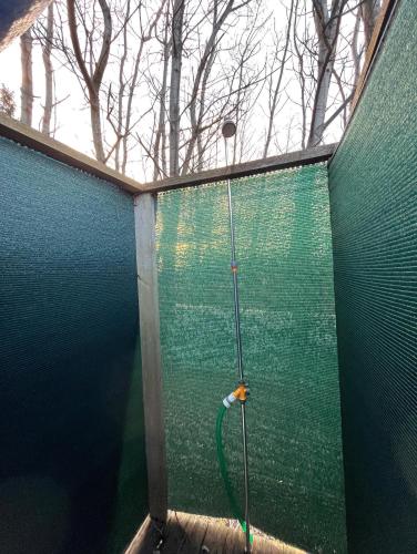 a shower in a room with a green wall at Ubytování na Horečky Ranči in Nový Jičín