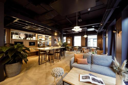 a living room with a couch and a table at Wilde Aparthotels Edinburgh Grassmarket in Edinburgh
