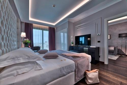 a large bedroom with a large bed and a television at Hotel President Terme in Abano Terme