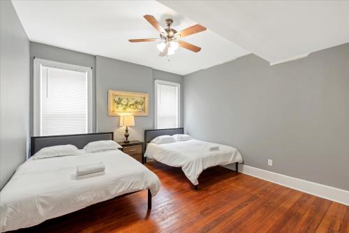 a bedroom with two beds and a ceiling fan at Historic First Floor Unit in STL - 5 Bedrooms in Soulard